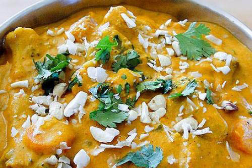 An assortment of vegetables and paneer cheese cooked in a mildly spiced creamy cashew and almond sauce