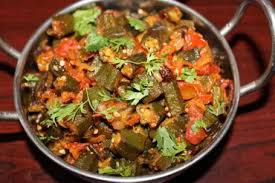 Okra sauteed with cumin , onion, bell peppers with onion and tomato sauce